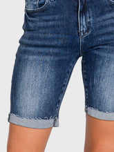 Load image into Gallery viewer, Woman wearing blue high rise bermuda denim shorts with rolled cuffs and a beige crop tee, casual summer style - 5