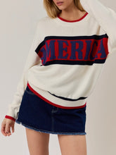 Load image into Gallery viewer, Oversized ivory knit America sweater with red and navy stripe graphic lettering, paired with denim mini skirt - 3