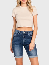 Load image into Gallery viewer, Woman wearing blue high rise bermuda denim shorts with rolled cuffs and a beige crop tee, casual summer style - 1