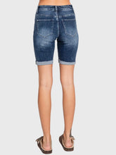 Load image into Gallery viewer, Woman wearing blue high rise bermuda denim shorts with rolled cuffs and a beige crop tee, casual summer style - 6