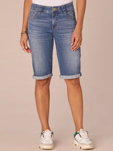 Load image into Gallery viewer, Women's medium blue artisanal denim Bermuda shorts with rolled cuffs and gold button, paired with white sneakers - 1