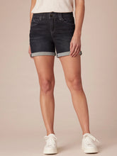 Load image into Gallery viewer, Women's dark wash denim midi shorts with cuffed hem and five-pocket style, paired with white sneakers - 1