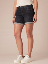 Load image into Gallery viewer, Women's dark wash denim midi shorts with cuffed hem and five-pocket style, paired with white sneakers - 4