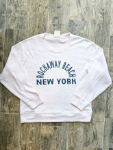 Load image into Gallery viewer, Pink thermal crew sweatshirt with Rockaway Beach New York graphic print in navy blue on wood floor background - 1
