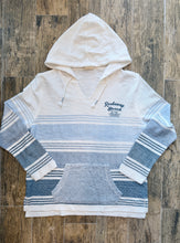 Load image into Gallery viewer, Rockaway Beach Stay Salty ombre blue striped baja hoodie with kangaroo pocket and hood on wood floor - 2