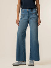 Load image into Gallery viewer, Meg High Rise Wide Leg Jeans in medium blue wash with patch pockets, paired with gray sneakers - 1