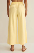 Load image into Gallery viewer, Scout Jersey Crop Flare Pant in Lemon Citrus yellow paired with matching tank top and strappy sandals - 4