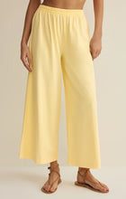 Load image into Gallery viewer, Scout Jersey Crop Flare Pant in Lemon Citrus yellow paired with matching tank top and strappy sandals - 5