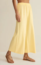 Load image into Gallery viewer, Scout Jersey Crop Flare Pant in Lemon Citrus yellow paired with matching tank top and strappy sandals - 3