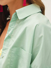 Load image into Gallery viewer, Oversized spearmint green cotton button-down shirt styled open over yellow gingham bikini top with white maxi skirt - 6
