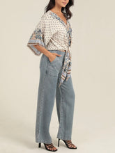 Load image into Gallery viewer, Ivory kimono sleeve tie front top with blue floral boho print, paired with light wash jeans - 2
