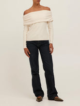 Load image into Gallery viewer, Studio City cream off-shoulder long sleeve top with folded neckline, paired with dark denim jeans, front view - 2
