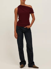 Load image into Gallery viewer, Laurel Tee in Dark Cherry, asymmetric one-shoulder draped burgundy top styled with dark wash jeans - 2
