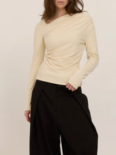 Load image into Gallery viewer, Harlow cream long sleeve top with asymmetric draped neckline and ruched waist, paired with black wide-leg trousers - 5
