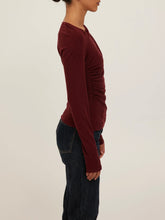 Load image into Gallery viewer, Harlow Long Sleeve Top in Dark Cherry with asymmetric draped neckline and ruched detail, worn in desert setting - 3
