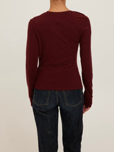 Load image into Gallery viewer, Harlow Long Sleeve Top in Dark Cherry with asymmetric draped neckline and ruched detail, worn in desert setting - 4
