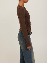 Load image into Gallery viewer, Harlow Long Sleeve Top in Dark Mocha with asymmetric neckline and ruched draping, styled with low-rise jeans - 3
