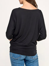 Load image into Gallery viewer, Black dolman boat neck top with 3/4 sleeves and relaxed fit, paired with blue jeans - 6
