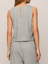 Load image into Gallery viewer, Woman wearing Sloane Knit Striped Top in Eclipse with matching striped pants, seated on olive chair - 2
