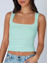 Load image into Gallery viewer, Woman wearing blue square neck shirred tank top with ruched sides paired with light wash denim skirt - 5
