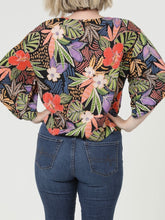 Load image into Gallery viewer, Woman wearing black multi tropical floral kimono sleeve tie front blouse with colorful leaf print and jeans - 2
