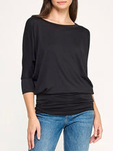 Load image into Gallery viewer, Black dolman boat neck top with 3/4 sleeves and relaxed fit, paired with blue jeans - 2
