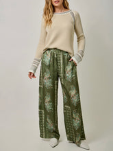 Load image into Gallery viewer, Womens almond cream knit sweater with crochet trim detail and striped cuffs paired with floral green pants - 6
