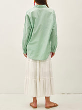 Load image into Gallery viewer, Oversized spearmint green cotton button-down shirt styled open over yellow gingham bikini top with white maxi skirt - 4

