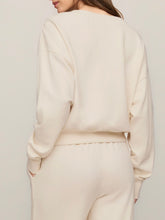 Load image into Gallery viewer, Woman wearing cream oversized Clubhouse Sweatshirt in Cloud with matching drawstring sweatpants, cozy loungewear set - 5
