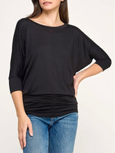 Load image into Gallery viewer, Black dolman boat neck top with 3/4 sleeves and relaxed fit, paired with blue jeans - 3
