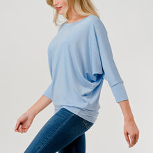Load image into Gallery viewer, Light blue dolman sleeve boat neck top with relaxed fit, paired with blue jeans on female model - 4
