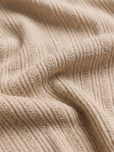 Load image into Gallery viewer, Woman wearing Landa Sweater Top in Natural, beige ribbed knit button-front crop cardigan with V-neck and blue jeans - 5

