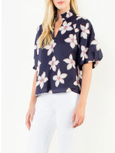 Load image into Gallery viewer, Navy floral puff sleeve top with white and red flower print, V-neck, paired with white pants - 3
