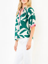 Load image into Gallery viewer, Silky Geo Top in green and white tropical leaf print with pink contrast trim, button-front, 3/4 sleeves - 2
