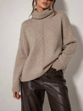 Load image into Gallery viewer, Oversized taupe textured turtleneck sweater with ribbed cuffs and hem, styled with dark brown leather pants - 1
