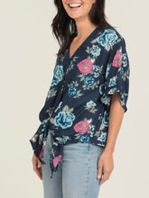 Load image into Gallery viewer, Navy floral kimono sleeve top with blue and pink roses, V-neck, tie front, and ruffle sleeves paired with jeans - 3
