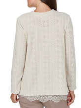 Load image into Gallery viewer, Oatmeal chevron knit long sleeve top with keyhole neckline and layered lace hem cami, paired with dark jeans - 3
