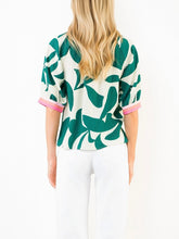 Load image into Gallery viewer, Silky Geo Top in green and white tropical leaf print with pink contrast trim, button-front, 3/4 sleeves - 5
