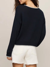 Load image into Gallery viewer, Woman wearing navy blue Coastal Sienna Sweater in Eclipse with white letter graphic and cream denim shorts - 2
