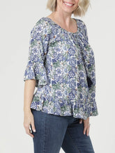 Load image into Gallery viewer, Floral Bell Sleeve Top in Blue Multi with tassel neckline and ruffle hem, paired with blue jeans - 3
