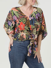 Load image into Gallery viewer, Woman wearing black multi tropical floral kimono sleeve tie front blouse with colorful leaf print and jeans - 3
