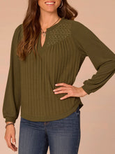 Load image into Gallery viewer, Women's olive green mix media notch neck top with ribbed front, lace yoke detail, and balloon sleeves paired with jeans - 1

