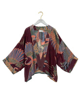 Load image into Gallery viewer, Crane Plum kimono jacket with paisley print layered over white lace blouse and dark jeans, boho style - 2
