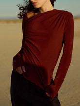 Load image into Gallery viewer, Harlow Long Sleeve Top in Dark Cherry with asymmetric draped neckline and ruched detail, worn in desert setting - 1
