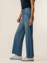 Load image into Gallery viewer, Meg High Rise Wide Leg Jeans in medium blue wash with patch pockets, paired with gray sneakers - 2
