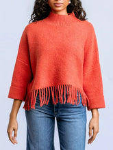 Load image into Gallery viewer, Sachi tangerine fringe sweater with mock neck, 3/4 sleeves, and boho fringe hem styled with blue jeans - 1
