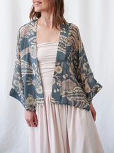 Load image into Gallery viewer, Rosa Blue floral kimono jacket with beige botanical print over blush pink strapless top and maxi skirt - 1
