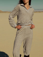 Load image into Gallery viewer, Woman wearing Slow Morning Polo in Heather Grey with matching joggers, styled in desert landscape - 1
