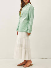 Load image into Gallery viewer, Oversized spearmint green cotton button-down shirt styled open over yellow gingham bikini top with white maxi skirt - 3
