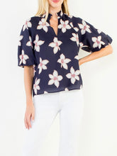 Load image into Gallery viewer, Navy floral puff sleeve top with white and red flower print, V-neck, paired with white pants - 7

